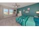 Bedroom with teal accent wall, ceiling fan, and view of water at 5216 Adega Way, Bradenton, FL 34211