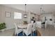 Bright dining room with round table and wicker chairs, near kitchen at 5216 Adega Way, Bradenton, FL 34211