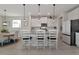 Kitchen with white cabinets, marble countertops, and island seating at 5216 Adega Way, Bradenton, FL 34211