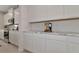 White kitchen cabinets and marble countertops offer ample storage at 5216 Adega Way, Bradenton, FL 34211