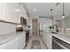 Modern kitchen with white cabinets, marble countertops, and stainless steel appliances at 5216 Adega Way, Bradenton, FL 34211