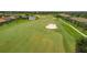 Aerial view of community, featuring homes, golf course, and lake at 5517 Palmer Cir # 101, Bradenton, FL 34211