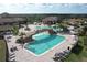 Resort-style pool with a waterfall feature, surrounded by lounge chairs and cabanas at 5517 Palmer Cir # 101, Bradenton, FL 34211