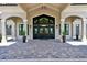 Elegant clubhouse entrance with arched entryway and landscaping at 5517 Palmer Cir # 101, Bradenton, FL 34211