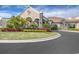 Grand entrance to the community clubhouse, featuring landscaping and a stone facade at 5517 Palmer Cir # 101, Bradenton, FL 34211