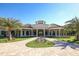 Mediterranean-style community clubhouse with a circular driveway and lush landscaping at 5517 Palmer Cir # 101, Bradenton, FL 34211