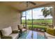 Relaxing screened porch with wicker furniture overlooking the golf course at 5517 Palmer Cir # 101, Bradenton, FL 34211