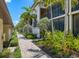 Brick-paved walkway with lush tropical landscaping at 5517 Palmer Cir # 101, Bradenton, FL 34211