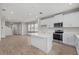 Modern kitchen with white cabinets and island at 5564 Coachwood Cv, Bradenton, FL 34211