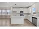 Modern kitchen with white cabinets and an island at 5564 Coachwood Cv, Bradenton, FL 34211