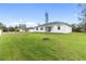 Large backyard with grassy area and new trees at 5595 Delight Ave, North Port, FL 34288