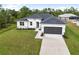 Single-Gathering home exterior with gray roof and white walls at 5595 Delight Ave, North Port, FL 34288