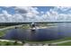 Aerial view of lakefront property with park and community building at 5625 Pipers Waite # 9, Sarasota, FL 34235