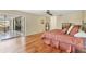 Bright bedroom featuring hardwood floors and French doors leading to a patio at 5625 Pipers Waite # 9, Sarasota, FL 34235