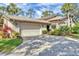 Attractive home exterior with a landscaped yard and paved driveway at 5625 Pipers Waite # 9, Sarasota, FL 34235