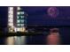 Night view of lakefront with fireworks at 5625 Pipers Waite # 9, Sarasota, FL 34235