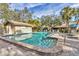 Inviting community pool with lounge chairs and a spa at 5625 Pipers Waite # 9, Sarasota, FL 34235