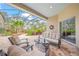 Spacious covered patio with seating area, overlooking a lush garden at 5826 Driftwood Pl # 34, Sarasota, FL 34231