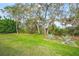 Spacious backyard with mature trees and lush landscaping at 5826 Driftwood Pl # 34, Sarasota, FL 34231