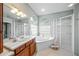 Bright bathroom featuring a corner tub and a walk-in shower at 5826 Driftwood Pl # 34, Sarasota, FL 34231