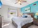 Main bedroom with ocean-themed wall art and comfortable bedding at 5826 Driftwood Pl # 34, Sarasota, FL 34231