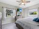 Main bedroom with mounted TV, dresser, and large windows at 5826 Driftwood Pl # 34, Sarasota, FL 34231