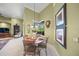 Charming breakfast nook with round table and four chairs at 5826 Driftwood Pl # 34, Sarasota, FL 34231