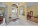 Elegant entryway with double doors and views to the dining room at 5826 Driftwood Pl # 34, Sarasota, FL 34231