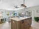 Modern kitchen island with white countertop and black hardware at 5826 Driftwood Pl # 34, Sarasota, FL 34231