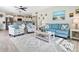 Bright living room with coastal decor and view into kitchen at 5826 Driftwood Pl # 34, Sarasota, FL 34231