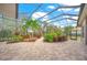 Relaxing screened patio with brick pavers and tropical plants at 5826 Driftwood Pl # 34, Sarasota, FL 34231