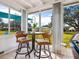 Relaxing sunroom with table and chairs, overlooking the lawn at 5826 Driftwood Pl # 34, Sarasota, FL 34231