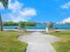 Peaceful waterfront walkway with benches and lush landscaping at 5826 Driftwood Pl # 34, Sarasota, FL 34231