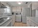 Kitchen with white appliances, light wood cabinets, and ample counter space at 5928 Welcome Rd # H4, Bradenton, FL 34207