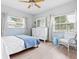 Bedroom with light blue walls, white dresser, and a comfy bed at 5936 Driftwood Ave # 16, Sarasota, FL 34231