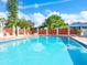 Inviting community pool with lounge chairs and a surrounding fence at 5936 Driftwood Ave # 16, Sarasota, FL 34231