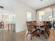 Light-filled dining room with wood table and chairs, and wood floors at 5936 Driftwood Ave # 16, Sarasota, FL 34231