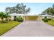 Front view of charming yellow house with carport at 5936 Driftwood Ave # 16, Sarasota, FL 34231