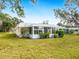 Back exterior view of a house with a sunroom addition at 5936 Driftwood Ave # 16, Sarasota, FL 34231