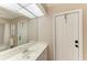 Bathroom with vanity, sink, and adjacent door at 601 Lakescene Dr, Venice, FL 34293