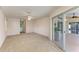 Bedroom with access to patio and bathroom, featuring carpet flooring at 601 Lakescene Dr, Venice, FL 34293