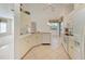 Well-equipped kitchen featuring white cabinets and tile floors at 601 Lakescene Dr, Venice, FL 34293