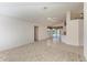 Open living room with tile and carpet flooring, leading to kitchen and patio at 601 Lakescene Dr, Venice, FL 34293