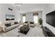 Living room with light beige sofas and large TV at 601 Lakescene Dr, Venice, FL 34293