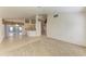 Living room with tile and carpeted floors and views into kitchen and dining areas at 601 Lakescene Dr, Venice, FL 34293