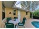 Relaxing poolside patio with table and chairs at 601 Lakescene Dr, Venice, FL 34293