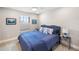 Main bedroom with a king-size bed, nightstand, and ocean-themed decor at 6299 Crested Eagle Ln, Nokomis, FL 34275