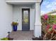 Dark gray front door with glass panels and brick walkway at 6299 Crested Eagle Ln, Nokomis, FL 34275