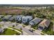 Two-story light blue house with gray roof and paver driveway at 6299 Crested Eagle Ln, Nokomis, FL 34275