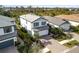 Two-story light blue house with gray roof and paver driveway at 6299 Crested Eagle Ln, Nokomis, FL 34275